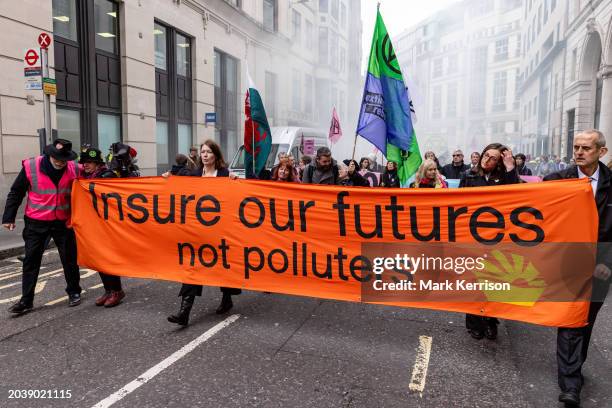 Climate activists from Extinction Rebellion march to Lloyds of London in protest against the role of the global insurance industry in supporting new...