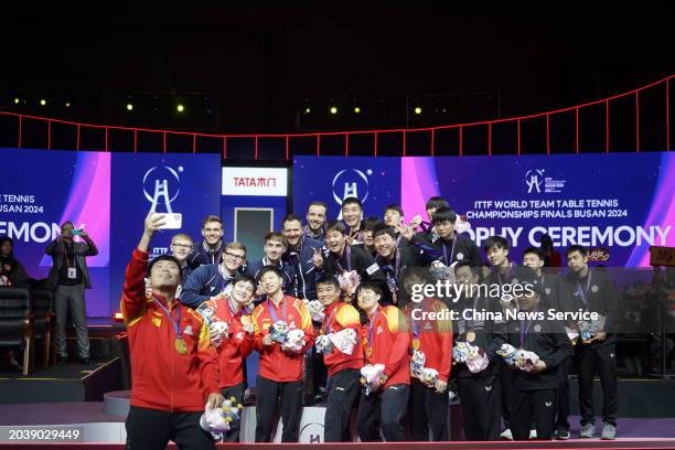 Gold medalists Team China, silver medalists Team France, bronze medalists Team Chinese Taipei and Team South Korea pose for a group selfie after the...