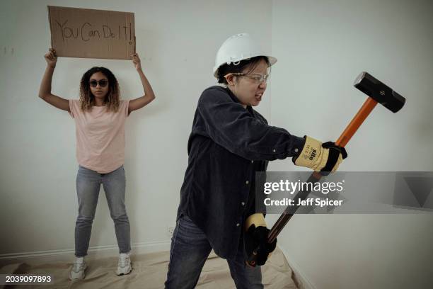 In this photo illustration released on February 29 doing a DIY task with another person holding up a sign say "You Can Do It". Research reveals over...