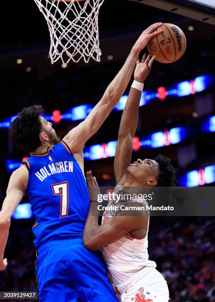 Chet Holmgren of the Oklahoma City Thunder blocks a shot from Amen Thompson of the Houston Rockets during the second half at Toyota Center on...