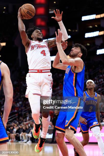 Jalen Green of the Houston Rockets drives to the net ahead of Chet Holmgren of the Oklahoma City Thunder during the second half at Toyota Center on...