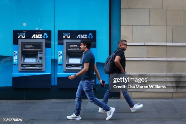 Pedestrians walk past an Australia & New Zealand Banking Group Ltd. Branch in Sydney on February 26, 2024 in Sydney, Australia. The recent approval...