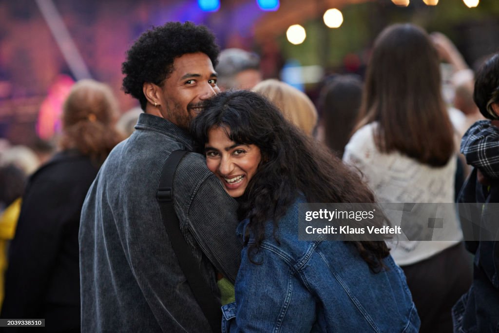 Cheerful couple enjoying concert together