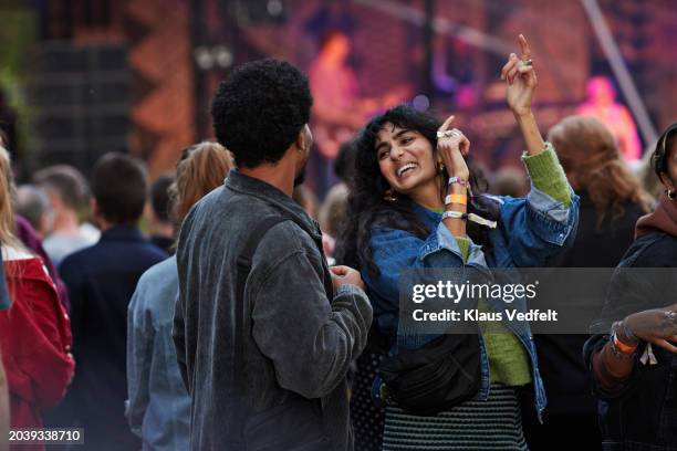cheerful woman dancing with boyfriend - crowd of people stock pictures, royalty-free photos & images
