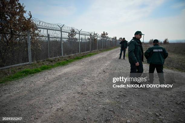 Bulgarian border police members patrol along the border fence at the Bulgaria-Turkey border near the village of Kapitan Andreevo on February 29,...