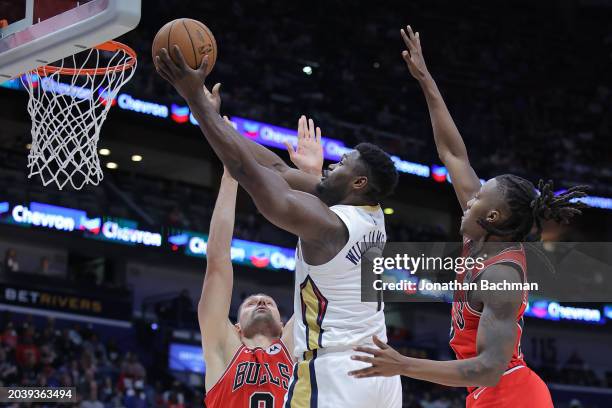 Zion Williamson of the New Orleans Pelicans shoots against Nikola Vucevic of the Chicago Bulls during the second half at the Smoothie King Center on...