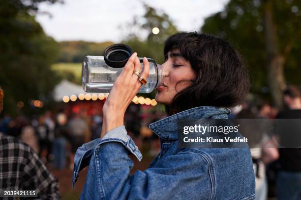 woman drinking water from bottle - pretty water bottles stock pictures, royalty-free photos & images