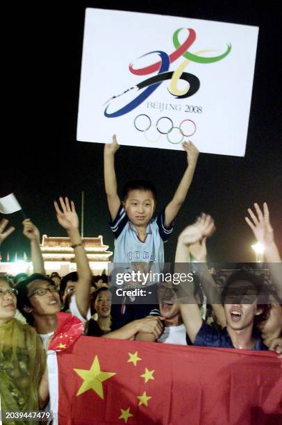 Chinese gather at Tiananmen Square in Beijing 13 July 2001 to celebrate after the capital city won the vote to host the 2008 Olympic Games. Thousands...