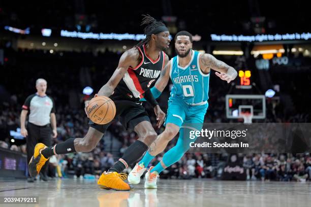 Jerami Grant of the Portland Trail Blazers dribbles the ball while defended by Miles Bridges of the Charlotte Hornets during the second half at Moda...