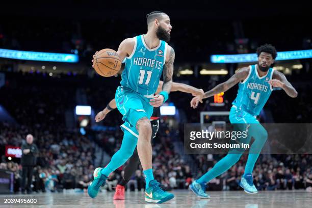 Cody Martin of the Charlotte Hornets moves the ball during the first half against the Portland Trail Blazers at Moda Center on February 25, 2024 in...