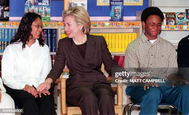 First Lady Hillary Rodham Clinton speaks with eighth grade students Teressa Singh and Daquan Lewis as she participates in a social studies class 29...