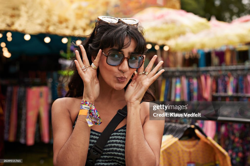 Happy woman puckering while wearing sunglasses