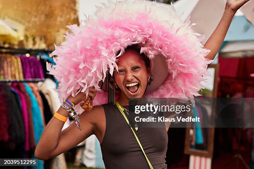 Carefree woman wearing pink hat while shouting Carefree woman wearing pink hat while shouting