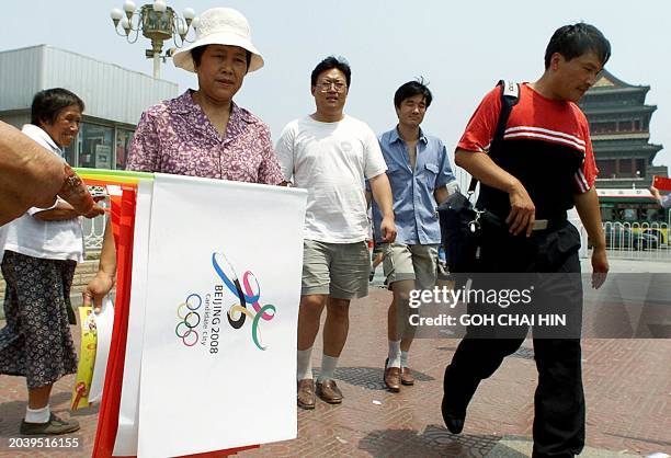 Vendors sells both the Chinese flags and the Olympic bid flags to visitors on Tiananmen Square in Beijing 15 July 2001. Hordes of new foreign...