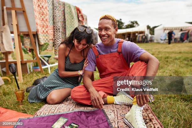 cheerful couple sitting with tarot cards at park - picknick decke stock-fotos und bilder