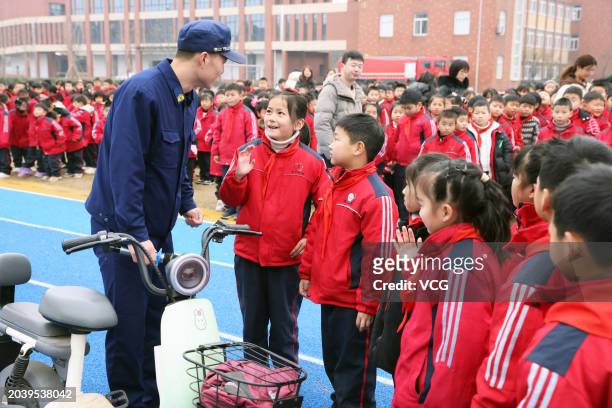 Primary school students answer questions about the safety of electric bicycle charging at a primary school on February 26, 2024 in Huzhou, Zhejiang...