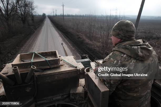 Ukrainian soldier of 47th Mechanized Brigade looks out from hatch during riding on M2 Bradley infantry fighting vehicle on Avdiivka direction on...