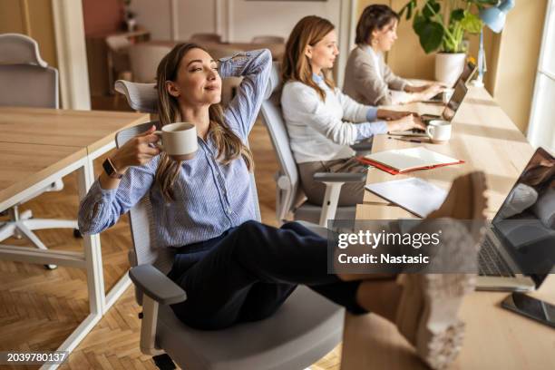 coffee, comfort, and contemplation - feet up stock pictures, royalty-free photos & images