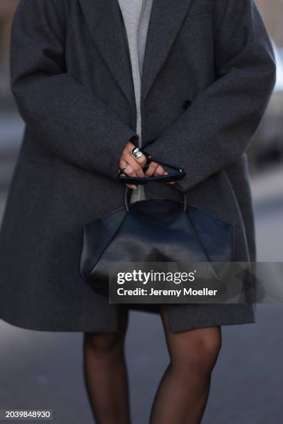 Sophia Geiss seen wearing Saint Laurent black sunglasses, silver earrings, COS dark grey oversized short wool coat, Arket grey cotton hooded zip...