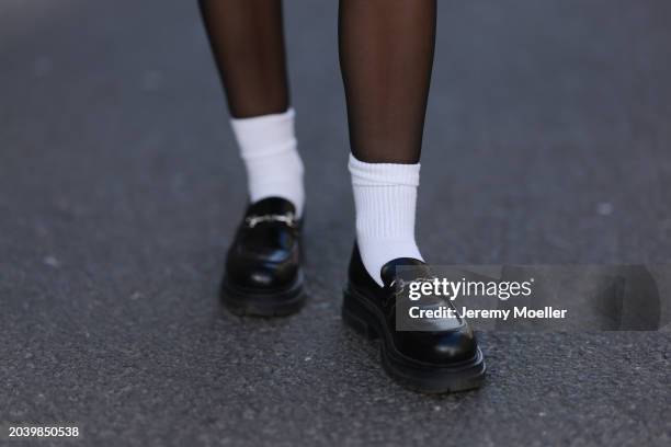 Sophia Geiss seen wearing black tights, white cotton socks and LeGer black leather loafers, on February 25, 2024 in Berlin, Germany.