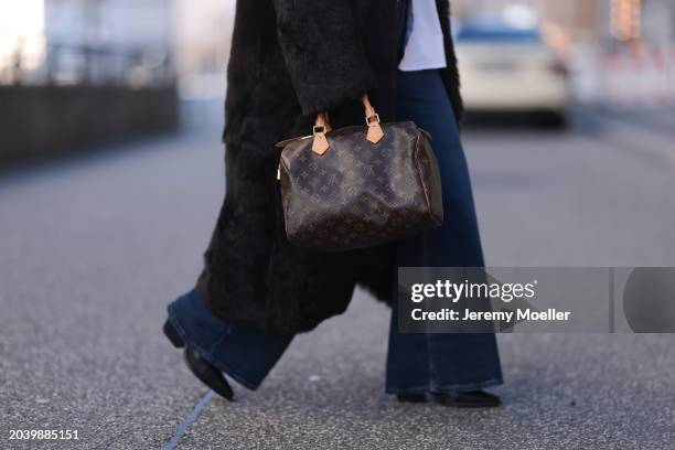 Sophia Geiss seen wearing Black Palms white cotton buttoned shirt, Levi's dark blue denim wide leg pants, Gant brown fake fur long coat, silver...
