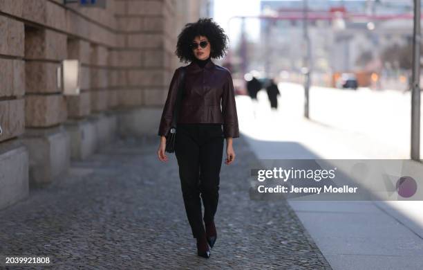 Julia Dalia seen wearing Tiffany & Co silver sunglasses, gold earrings, Arket black wool knit high neck sweater, burgundy red leather cropped jacket,...
