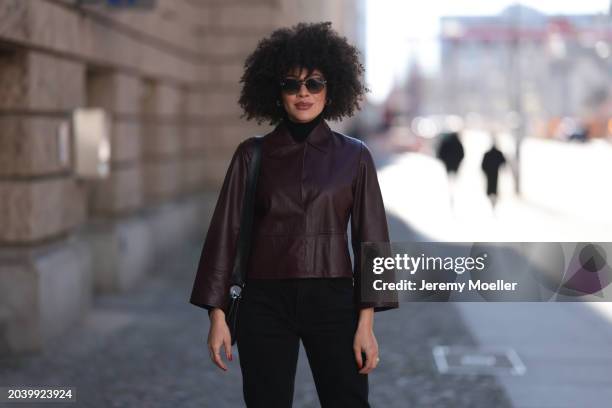 Julia Dalia seen wearing Tiffany & Co silver sunglasses, gold earrings, Arket black wool knit high neck sweater, burgundy red leather cropped jacket,...