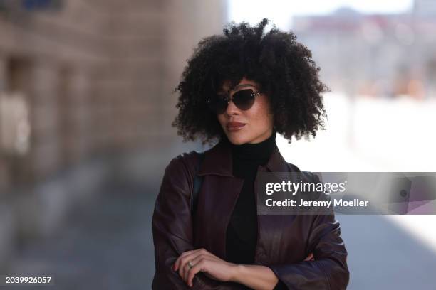 Julia Dalia seen wearing Tiffany & Co silver sunglasses, gold earrings, Arket black wool knit high neck sweater, burgundy red leather cropped jacket,...