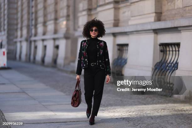 Julia Dalia seen wearing Tiffany & Co silver sunglasses, gold earrings, Arket black wool knit high neck sweater, black wool knit colorful flower...