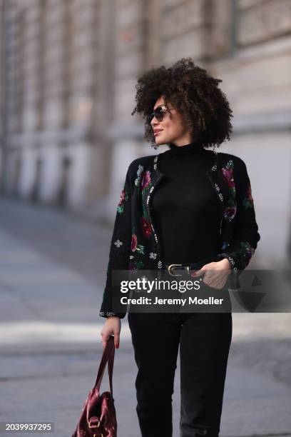 Julia Dalia seen wearing Tiffany & Co silver sunglasses, gold earrings, Arket black wool knit high neck sweater, black wool knit colorful flower...