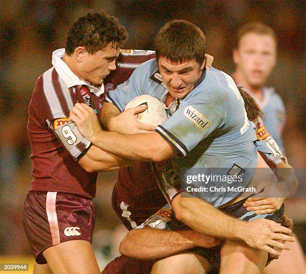 Nathan Hindmarsh of NSW is tackled by P.J Marsh of QLD during the second game of the NRL State of Origin series played at ANZ Stadium in Brisbane,...