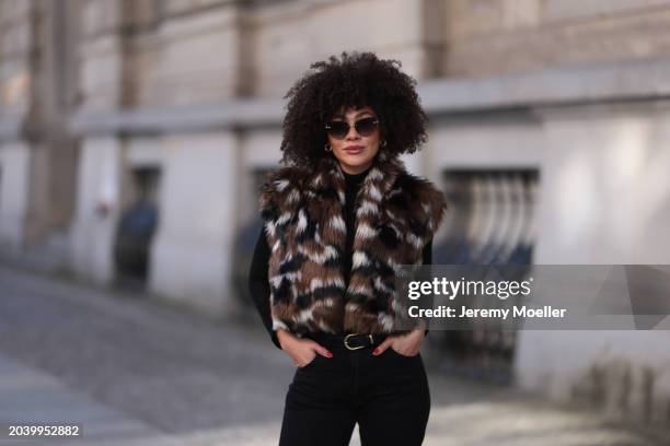 Julia Dalia seen wearing Tiffany & Co silver sunglasses, gold earrings, Arket black wool knit turtleneck sweater, brown / black / white fake fur...