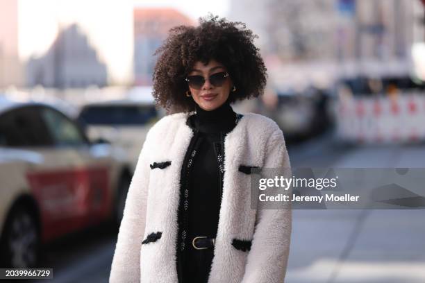 Julia Dalia seen wearing Tiffany & Co silver sunglasses, gold earrings, Arket black wool knit turtleneck sweater, black wool knit embroidered...