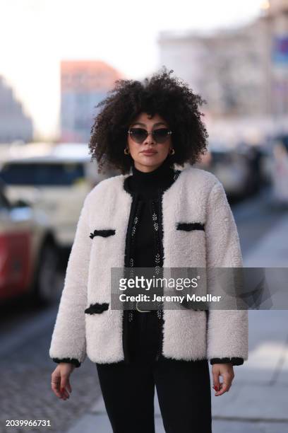 Julia Dalia seen wearing Tiffany & Co silver sunglasses, gold earrings, Arket black wool knit turtleneck sweater, black wool knit embroidered...