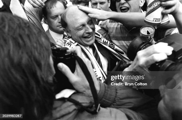 Leader of the Labour Party Neil Kinnock is mobbed by football fans as he arrives at Wembley Stadium for the FA Cup final between Tottenham Hotspur...