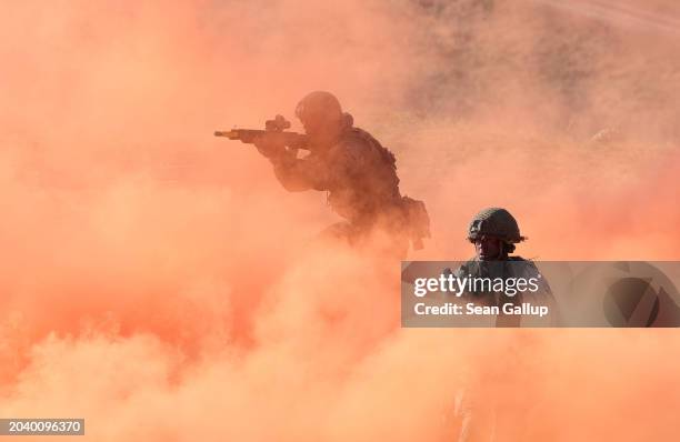 Soldiers of the United Kingdom's 2nd Battalion Royal Anglian infantry unit storms an enemy position in a simulated attack during the NATO "Brilliant...