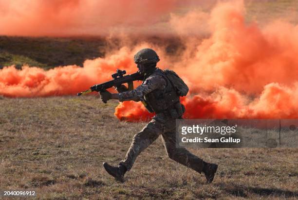 Soldier of the United Kingdom's 2nd Battalion Royal Anglian infantry unit storms an enemy position in a simulated attack during the NATO "Brilliant...