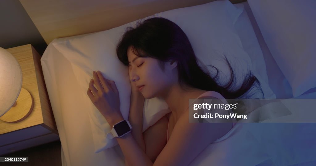 Asian woman sleep with smartwatch