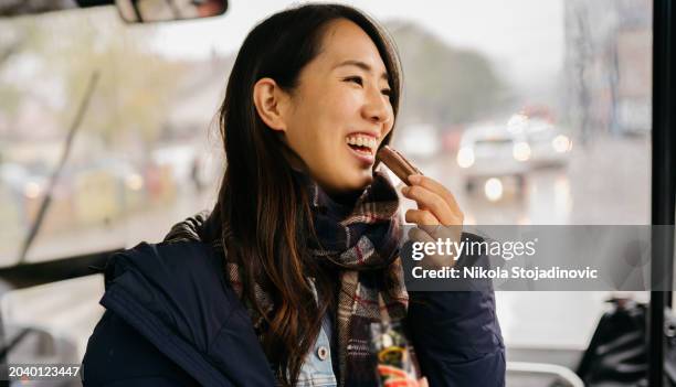 eating chocolate bar while traveling by a bus - chocolate bar stock pictures, royalty-free photos & images