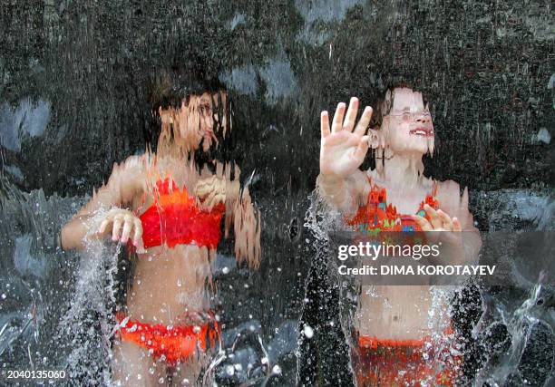 Children play in a fountain in the Alexandrovsky garden near the Kremlin in the center of Moscow, 29 May 2007. Moscow sweltered 29 May 2007 in a...