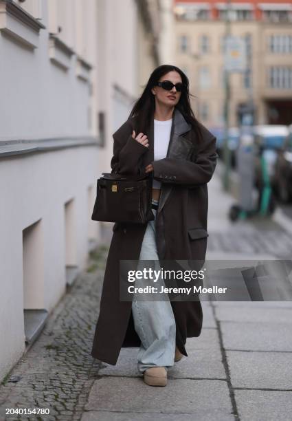 Anna Winter seen wearing Prada black Symbole sunglasses, Edited white cotton basic cropped shirt, The Mannei brown oversized wool long coat with...