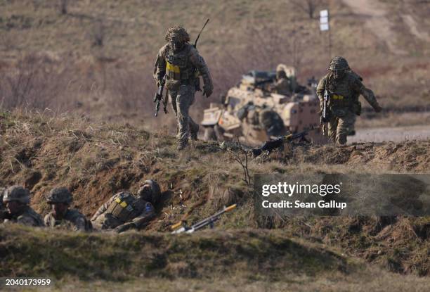 Soldiers of the United Kingdom's 2nd Battalion Royal Anglian infantry unit storm an enemy position in a simulated attack during the NATO "Brilliant...