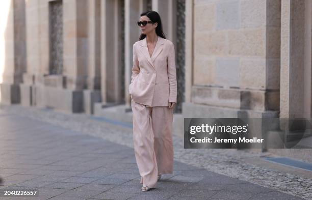 Leo Eberlin seen wearing YSL brown tortoise sunglasses, Leo Mathild diamond jewelry / rings and bracelet, Marc Cain light pink elegant blazer jacket,...