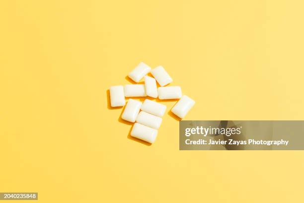 bubble gum on a yellow background - artificial sweetener stock pictures, royalty-free photos & images