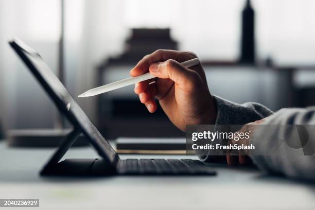 close-up of professional working with stylus on digital tablet - hand stylus stock pictures, royalty-free photos & images