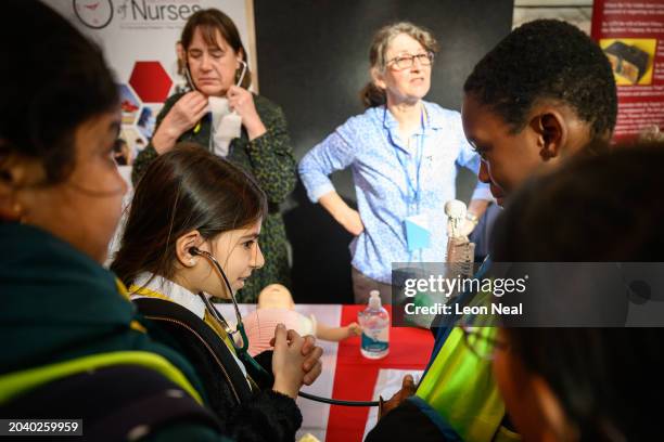 Primary school children learn how to use a stethoscope during the London Careers Festival at Guildhall on February 26, 2024 in London, England. The...