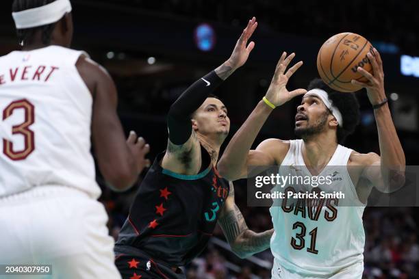 Jarrett Allen of the Cleveland Cavaliers is defended by Kyle Kuzma of the Washington Wizards at Capital One Arena on February 25, 2024 in Washington,...