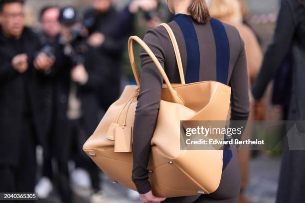 Ginevra Mavilla wears a brown striped bodysuit, a large beige leather bag, outside Ferragamo, during the Milan Fashion Week - Womenswear Fall/Winter...