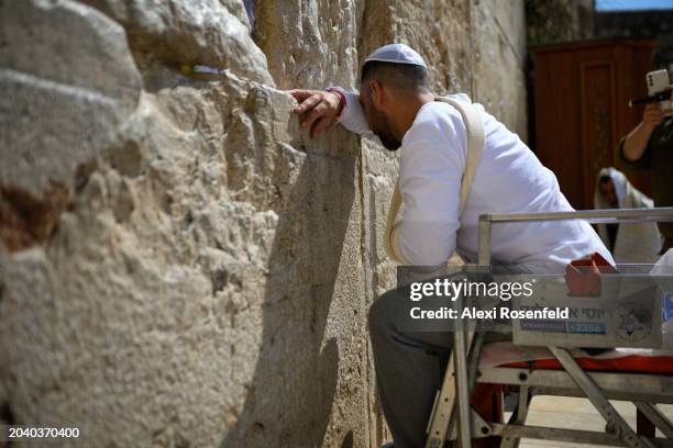 Master Sergent Inon Ben Ami, who was injured on February 12th fighting in Khan Younis, prays at the Western Wall during a surprise visit on February...