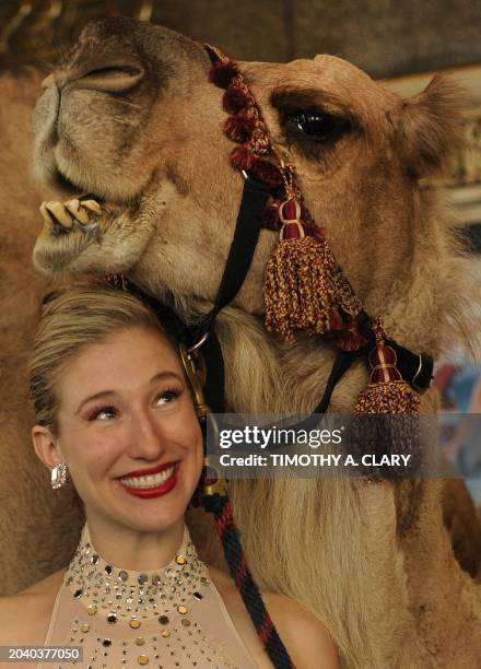 Radio City Rockette Laura Danleski holds a camel as the animals report to their first day of rehearsals at Radio City Music Hall October 17, 2011in...